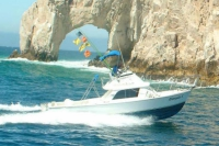 Returning from the Cabo fishing grounds with Dorado, Marlin & Wahoo flags flying on Fiesta Sportfishing's 31' Bertram "Dorado I".