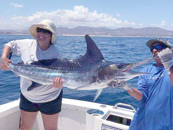 A happy gal with her first Cabo Striped Marlin Release while fishing on Fiesta Sportfishing 31 ft "Dorado I" 